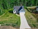 Aerial view of a beautifully landscaped home with an inviting driveway and a well-maintained yard at 5389 Salem Woods Dr # 12, Graham, NC 27253