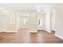 Bright living room featuring wood floors, white trim, coffered ceilings, and plenty of natural light at 5389 Salem Woods Dr # 12, Graham, NC 27253