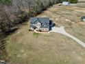 Aerial view showcasing the home's spacious lot, long driveway, three-car garage and serene surroundings at 5439 Cokesbury Rd, Fuquay Varina, NC 27526