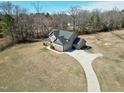 An aerial view shows the home on a large lot with a long driveway and an attached three-car garage at 5439 Cokesbury Rd, Fuquay Varina, NC 27526