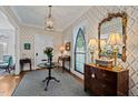 Elegant foyer featuring decorative wallpaper, stained glass window, and hardwood flooring at 809 Wayne Dr, Raleigh, NC 27608