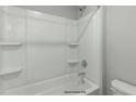 Clean bathroom shower/tub with built-in shelves and a neutral color scheme at 54 Merle Dr, Wendell, NC 27591