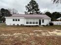 Charming single-story home featuring a metal roof, light-colored siding and a well-maintained lawn at 102 Sue Ave, Dunn, NC 28334