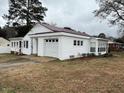 Charming single-story home with attached garage, light-colored siding and a well-maintained lawn at 102 Sue Ave, Dunn, NC 28334