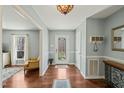Bright foyer with hardwood floors and elegant lighting fixture at 11424 Horsemans Trl, Raleigh, NC 27613