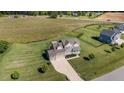 Overhead shot of a well-manicured lawn, traditional home, and lush landscaping at 124 Brookstone Way, Angier, NC 27501