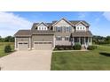 Attractive two-story home featuring a three-car garage and a well-kept front yard at 124 Brookstone Way, Angier, NC 27501