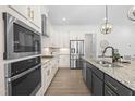 Modern kitchen features granite countertops, stainless steel appliances, and a stylish kitchen island at 124 Ferrell W Rd, Apex, NC 27523