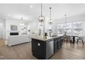 Spacious open-concept kitchen featuring a large island, modern appliances, and a dining area with ample natural light at 124 Ferrell W Rd, Apex, NC 27523