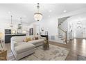 Open-concept living room showcases hardwood floors, natural light, and seamless kitchen access at 124 Ferrell W Rd, Apex, NC 27523