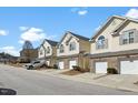 A row of inviting townhomes with well-manicured lawns and private garages at 1306 Plexor Ln, Knightdale, NC 27545