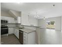 Open kitchen with stainless steel appliances, granite countertops, and wood flooring at 1306 Plexor Ln, Knightdale, NC 27545