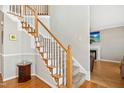 Elegant staircase with wooden handrail and white spindles, leading to the upper level of the home at 1421 Harvey Johnson Rd, Raleigh, NC 27603