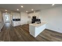 Contemporary kitchen boasts white cabinetry, stainless steel appliances, and a stylish dark backsplash at 1573 Wendell Valley Blvd, Wendell, NC 27591