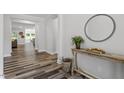 Bright hallway featuring hardwood floors, stylish decor, and an open floor plan at 163 English Violet Lane Ln, Raleigh, NC 27610