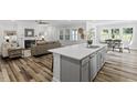Modern open-concept kitchen with a large island, stainless appliances, and adjacent living area at 163 English Violet Lane Ln, Raleigh, NC 27610