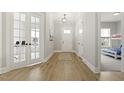 Inviting hallway features luxury vinyl floors and a view of a bedroom or play area at 1737 Fence Post Rd, Wendell, NC 27591