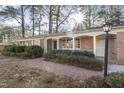 Inviting brick home with manicured bushes and a brick walkway to the front door at 2201 Knollwood Dr, Sanford, NC 27330