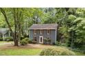 Charming two-story home with red shutters surrounded by lush greenery, creating a serene and inviting atmosphere at 2301 Pastille Ln, Raleigh, NC 27612