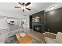 Open-concept living room with fireplace that flows seamlessly into the modern kitchen at 251 Olde Pl, Zebulon, NC 27597