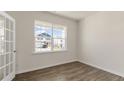 Bright room featuring a large window and wood floors, offering a versatile space at 281 Hanging Elm Ln, Fuquay Varina, NC 27526