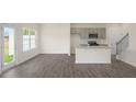 Open-concept kitchen with gray cabinets, stainless steel appliances, and a central island at 292 Perseus St, Angier, NC 27501