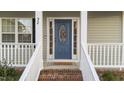 Inviting front entrance with a decorative blue door and stylish welcome mat at 32 Harkers Island Dr, Garner, NC 27529