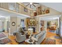 Spacious living room with stone fireplace, hardwood floors, and vaulted ceilings at 5300 Grand Gate Dr, Raleigh, NC 27613