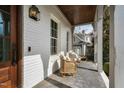 Relaxing front porch featuring comfortable seating, stylish lighting, and views of the surrounding neighborhood at 543 Guilford Cir, Raleigh, NC 27608