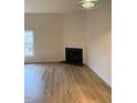 Bright living room with a cozy fireplace and modern light-colored wood floors at 6102 Highcastle Ct, Raleigh, NC 27613