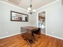 Dining room with hardwood floors, light gray walls, and a chandelier at 6469 New Market Way, Raleigh, NC 27615
