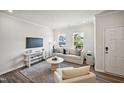 Comfortable living area with modern decor, including a soft sofa, stylish rug, and ample natural light at 659 Mirkwood Ave, Apex, NC 27523
