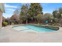 Beautiful pool with a waterfall feature and mature landscaping that enhances its privacy at 836 Canyoncreek Ln, Fuquay Varina, NC 27526
