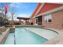 Stunning pool featuring stone accents, a pergola-covered patio, and a lush, private backyard at 836 Canyoncreek Ln, Fuquay Varina, NC 27526