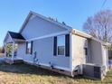 Exterior view of the home, highlighting the siding, windows, and well-maintained landscaping at 103 1St St, Haw River, NC 27258