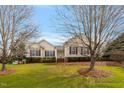 Charming home featuring a manicured lawn, mature trees and inviting front porch at 1212 Red Brick Rd, Garner, NC 27529