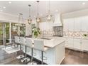 Bright, eat-in kitchen with white cabinets, stainless steel appliances, and a modern island with seating at 123 Stone Park Dr, Wake Forest, NC 27587