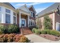 Charming two-story brick home with manicured lawn and inviting front entryway at 12409 Village Gate Way, Raleigh, NC 27614