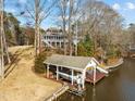 Dock with boat slip and sitting area on the water's edge at 1315 Sagamore Dr, Louisburg, NC 27549