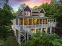 Charming screened porch and staircase with outside seating area at 1315 Sagamore Dr, Louisburg, NC 27549