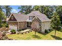 Attractive stone house on a grassy lot with attached two-car garage at 1315 Sagamore Dr, Louisburg, NC 27549