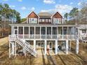 Rear exterior view of beautiful house with a spacious screened porch and lower covered patio for outdoor enjoyment at 1315 Sagamore Dr, Louisburg, NC 27549
