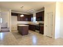 Spacious kitchen with an island, stainless steel appliances, and dark cabinets at 2015 Tennessee Road Rd, Durham, NC 27704