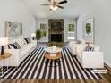 Bright living room with stone fireplace, plush seating, and modern decor at 204 Lopez Ln, Clayton, NC 27527