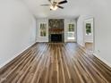 Spacious living area with stone fireplace, neutral walls, and hardwood floors at 204 Lopez Ln, Clayton, NC 27527