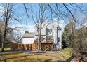 The backyard features a wooden deck, a covered area, and mature trees in a peaceful setting at 205 Caniff Ln, Cary, NC 27519