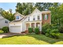 Well-maintained home with green lawn and attached two car garage at 2310 Woodbury Dr, Hillsborough, NC 27278