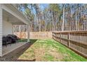 Fenced backyard with a covered patio and a small grassy area at 290 Forest Meadow Ln, Franklinton, NC 27525