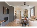 Bright living room features wood floors, a modern fireplace, neutral decor, and ample natural light at 320 Catheys Crk Cir, Wendell, NC 27591