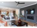 Open-concept living room flows into the dining area, featuring modern decor and hardwood floors at 320 Catheys Crk Cir, Wendell, NC 27591